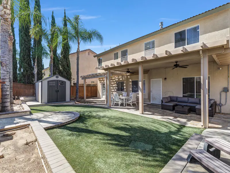 Lawn, patio and garden shed in the backyard